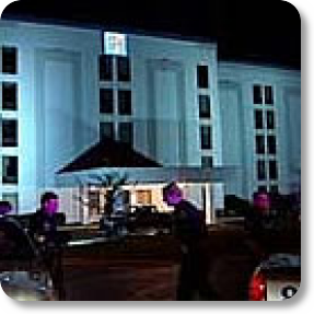 Man sitting in car shot in motel parking lot PHOTO