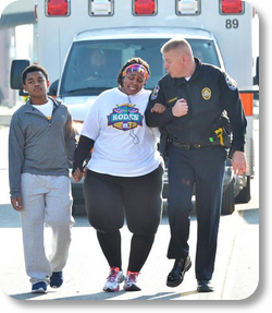 Image of LMPD officer helping 10K runner cross finish line viewed more than 1 million times PHOTO